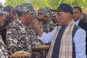 Defence Minister Rajnath Singh distributes sweets to Air Force personnel at Bhuj Air Force Station, Gujarat, on May 16, 2025.