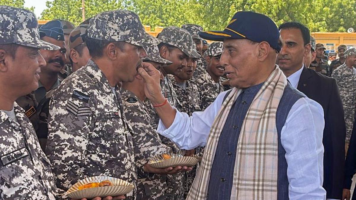 Defence Minister Rajnath Singh distributes sweets to Air Force personnel at Bhuj Air Force Station, Gujarat, on May 16, 2025.