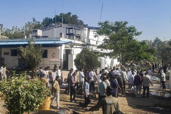 Rescue teams and local residents assemble at the site of the explosives factory blast